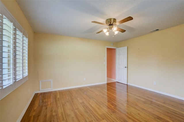 spare room with ceiling fan and light hardwood / wood-style flooring