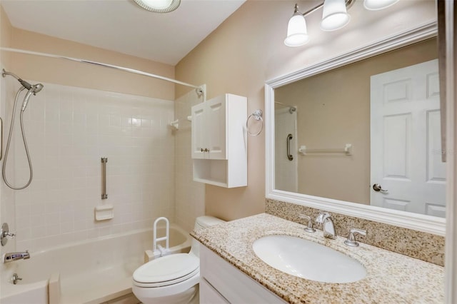 full bathroom featuring toilet, vanity, and tiled shower / bath