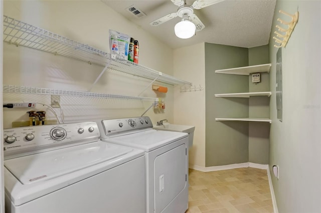 clothes washing area featuring light tile floors, ceiling fan, a textured ceiling, washer and clothes dryer, and sink