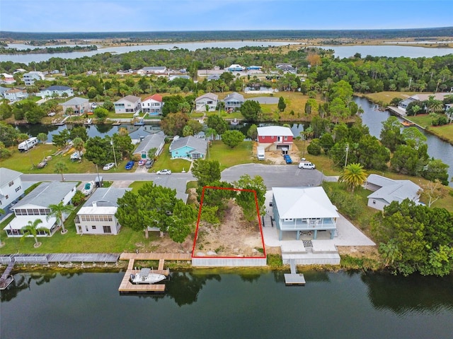 birds eye view of property featuring a residential view and a water view