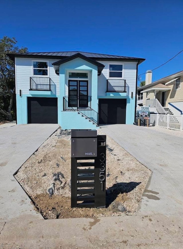 view of front of property featuring an attached garage and concrete driveway