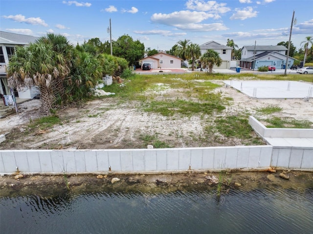 view of yard with a water view and fence