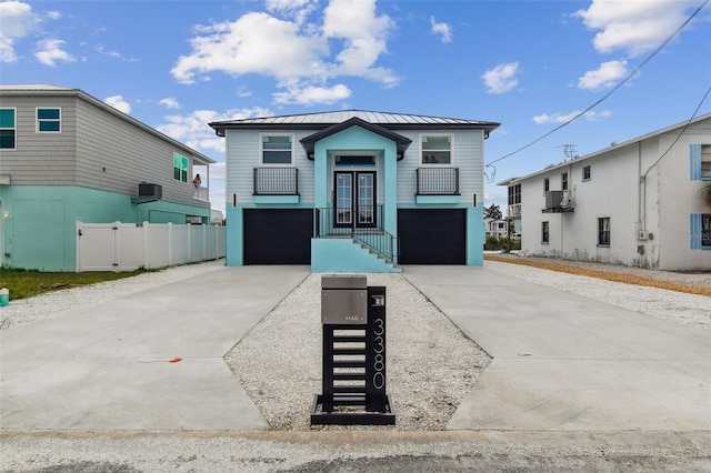 3380 Holly Springs Dr, Hernando Beach, FL 34607 - view of front of house featuring a garage, concrete driveway, a metal roof, and a standing seam roof