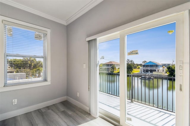 3380 Holly Springs Dr, Hernando Beach, FL 34607 - doorway to outside with a water view, wood finished floors, and crown molding