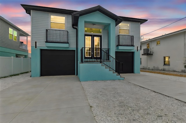 3380 Holly Springs Dr, Hernando Beach, FL 34607 - view of front of home with a garage, driveway, a balcony, and french doors