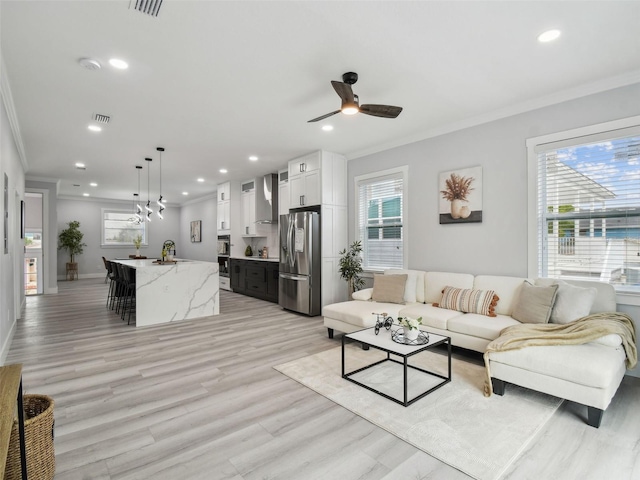 3380 Holly Springs Dr, Hernando Beach, FL 34607 - living area with crown molding, ceiling fan, recessed lighting, and light wood-type flooring