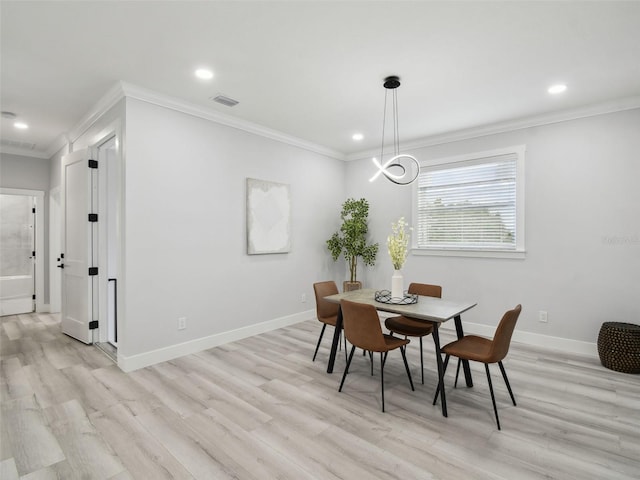 3380 Holly Springs Dr, Hernando Beach, FL 34607 - dining space with light wood finished floors, ornamental molding, and recessed lighting