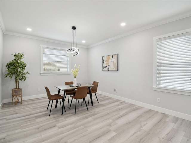 3380 Holly Springs Dr, Hernando Beach, FL 34607 - dining space with light wood-style flooring, recessed lighting, and crown molding