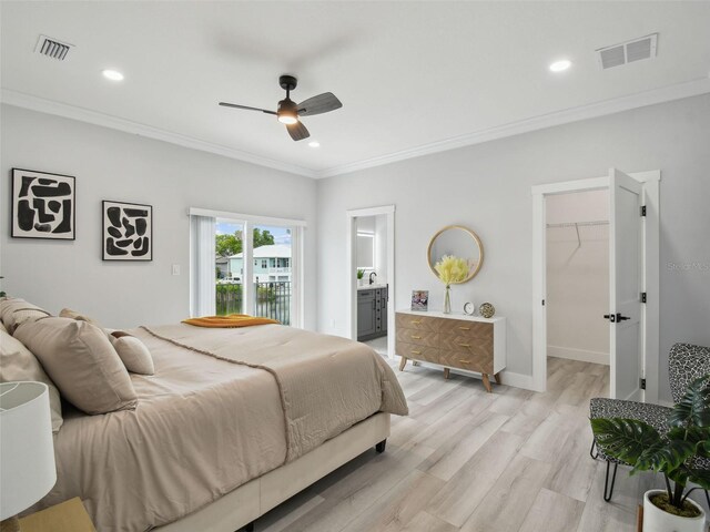 3380 Holly Springs Dr, Hernando Beach, FL 34607 - bedroom with crown molding, light wood-style floors, recessed lighting, a walk in closet, and ensuite bath