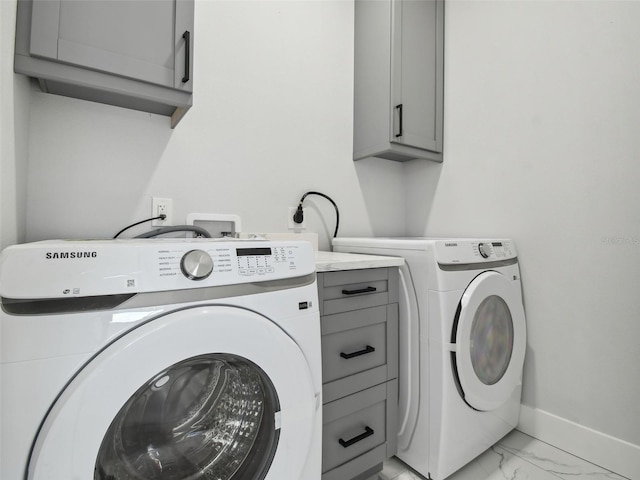 3380 Holly Springs Dr, Hernando Beach, FL 34607 - washroom featuring cabinet space, light marble finish floors, and washer and clothes dryer