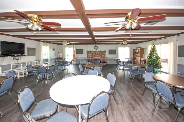 dining area with dark hardwood / wood-style floors, coffered ceiling, ceiling fan, and beamed ceiling