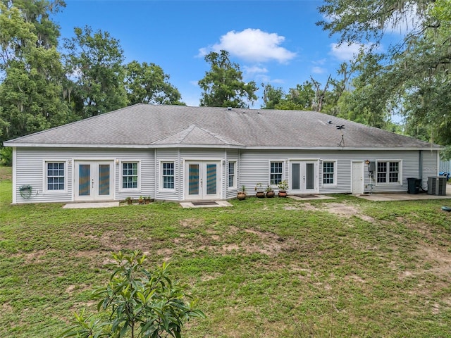 back of house with a yard, central AC, a patio area, and french doors