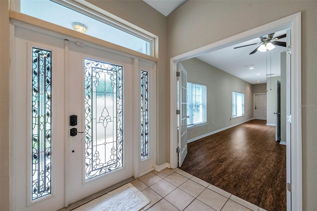 entryway featuring plenty of natural light, light tile patterned flooring, and ceiling fan