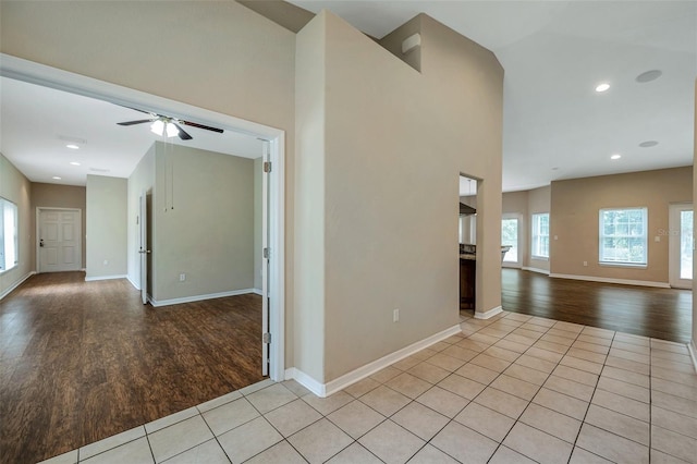 tiled empty room featuring ceiling fan