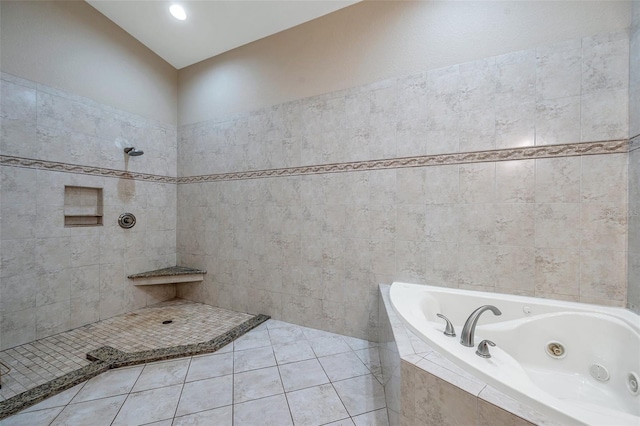 bathroom featuring separate shower and tub, tile patterned flooring, and tile walls