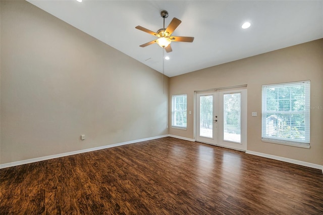 spare room with ceiling fan, dark hardwood / wood-style floors, vaulted ceiling, and french doors