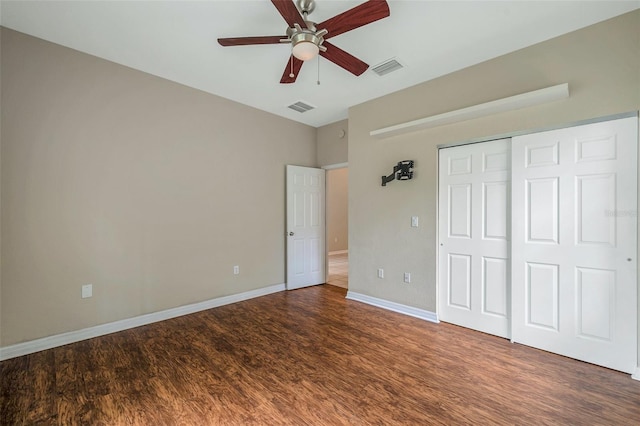 unfurnished bedroom featuring ceiling fan, dark hardwood / wood-style floors, and a closet