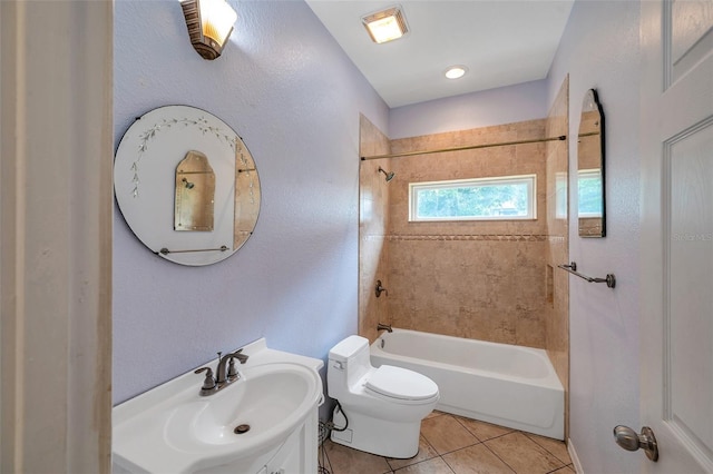 full bathroom with tile patterned flooring, vanity, tiled shower / bath combo, and toilet