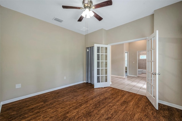 spare room with ceiling fan, french doors, and light hardwood / wood-style flooring