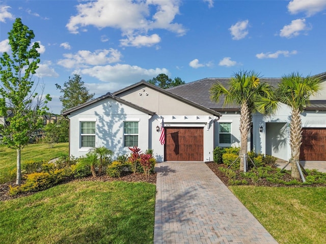 single story home with a front yard and a garage