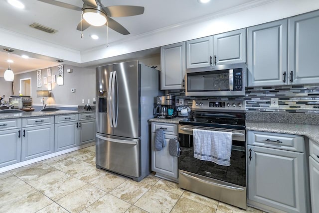 kitchen with tasteful backsplash, light tile floors, stainless steel appliances, ceiling fan, and ornamental molding