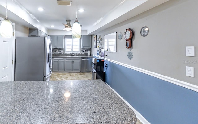 kitchen with stainless steel appliances, decorative light fixtures, light tile floors, ceiling fan, and sink