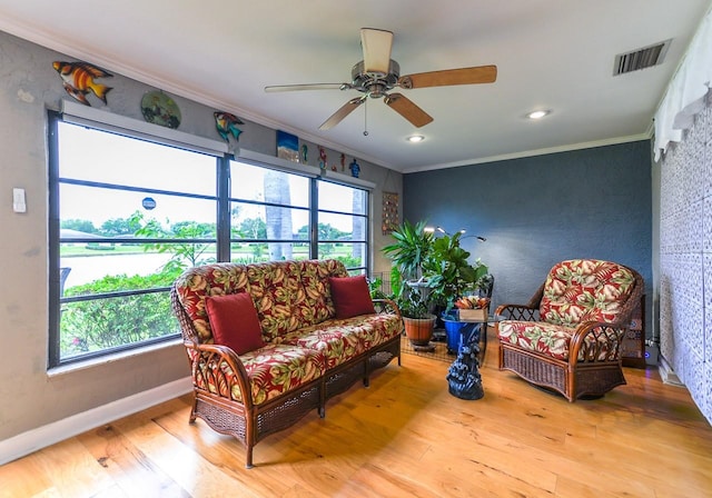 sitting room featuring crown molding, ceiling fan, and light hardwood / wood-style flooring