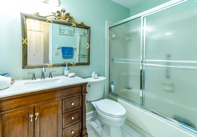 full bathroom featuring shower / bath combination with glass door, tile floors, toilet, and vanity