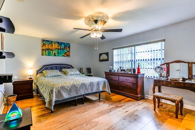 bedroom with ceiling fan and light hardwood / wood-style flooring