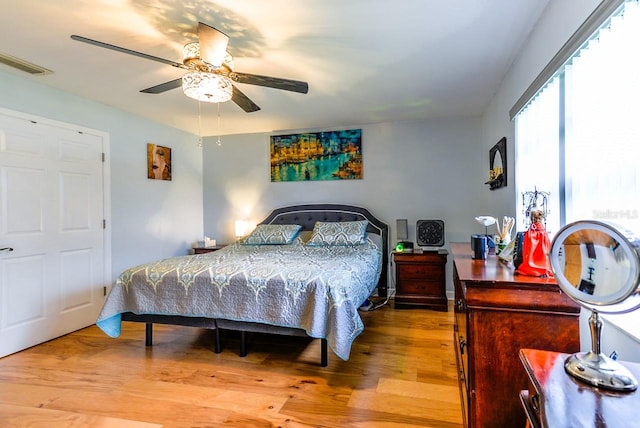 bedroom with light hardwood / wood-style floors and ceiling fan