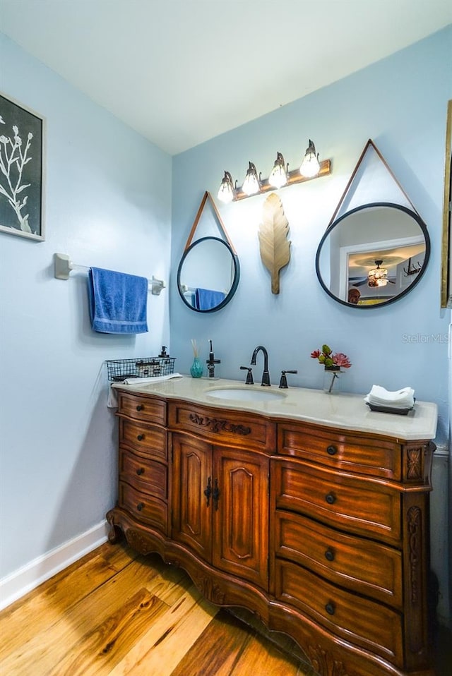 bathroom with vanity and hardwood / wood-style flooring