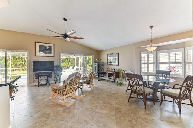 tiled dining space with vaulted ceiling and ceiling fan