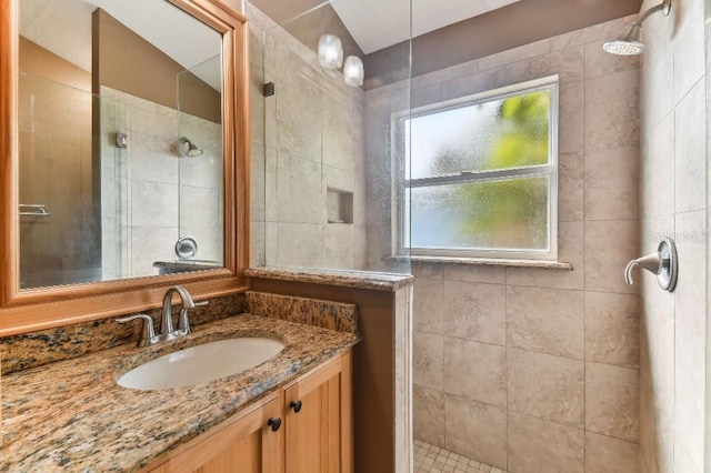 bathroom featuring vanity and a tile shower