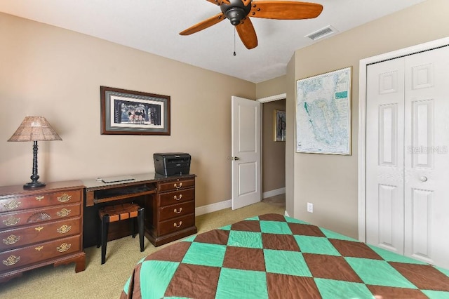 bedroom featuring ceiling fan, light colored carpet, and a closet