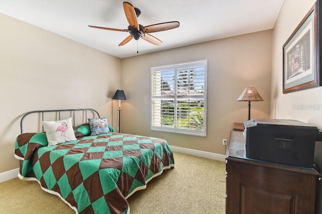 bedroom featuring light colored carpet and ceiling fan