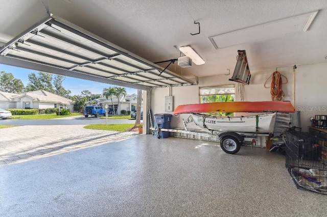 garage with a carport and a garage door opener