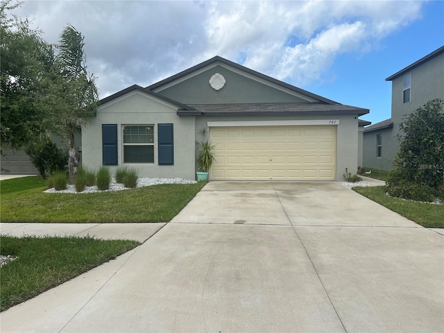 ranch-style house featuring a front lawn and a garage