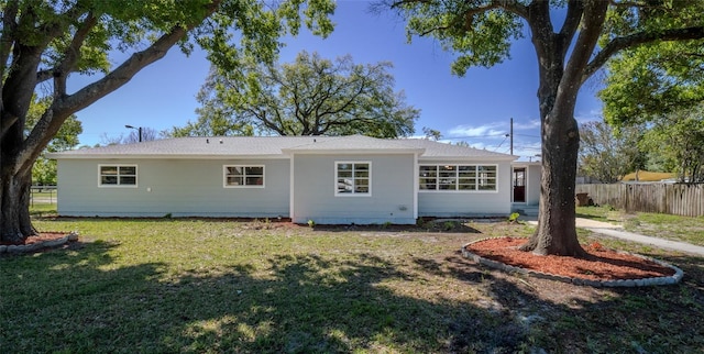 back of house featuring a yard