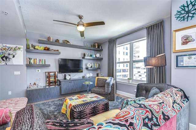 living room featuring a textured ceiling, hardwood / wood-style floors, and ceiling fan