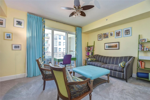 carpeted living room featuring ceiling fan