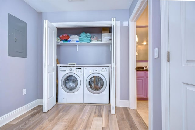 laundry room with light hardwood / wood-style floors and independent washer and dryer