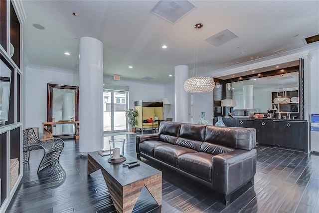 living room with ornamental molding, dark hardwood / wood-style floors, and sink