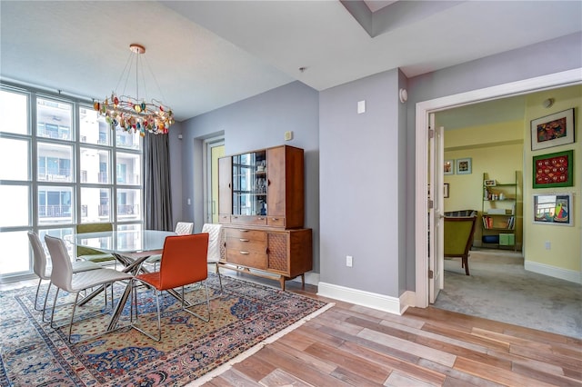 dining room featuring a notable chandelier and light wood-type flooring