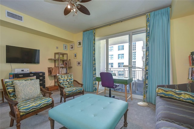 living room with ceiling fan and carpet floors