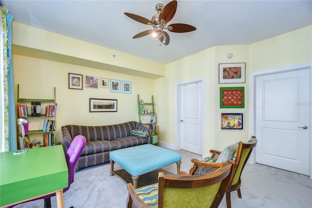 carpeted living room featuring ceiling fan