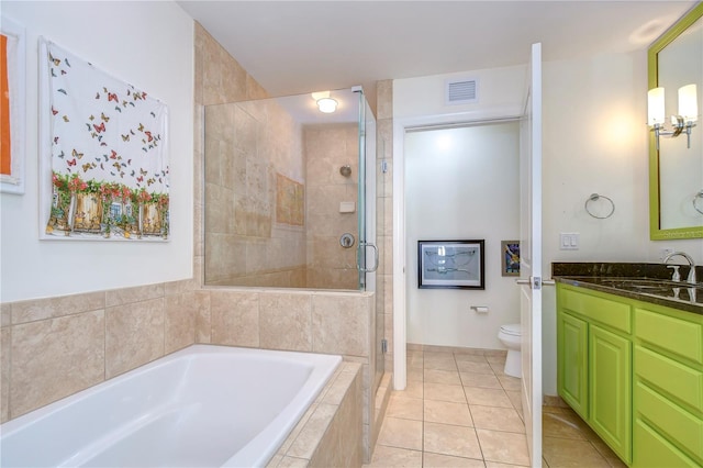 full bathroom featuring toilet, tile flooring, vanity, and separate shower and tub