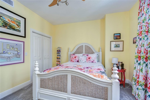 bedroom with a closet, dark carpet, and ceiling fan