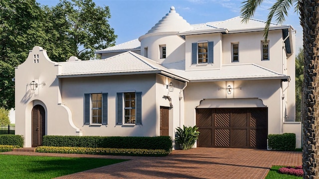 view of front of house featuring an attached garage, decorative driveway, and stucco siding