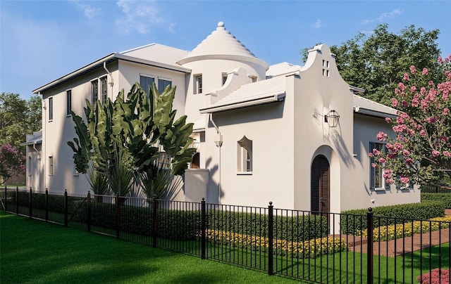 view of front of house with a front lawn, fence, and stucco siding