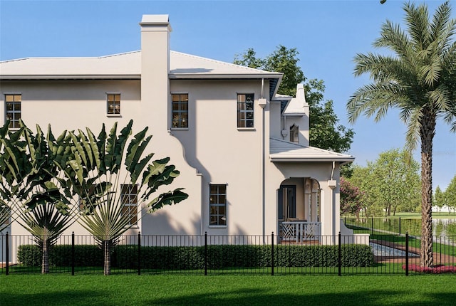 view of home's exterior featuring a chimney, fence, a lawn, and stucco siding